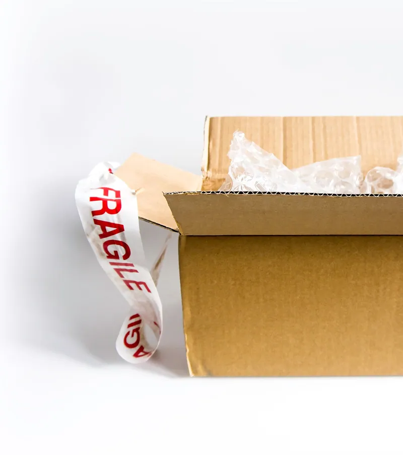 Open shipping box with fragile tape and packing material